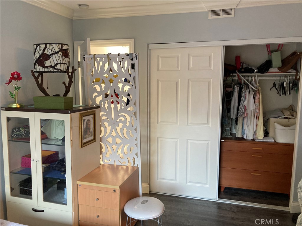 809 North Spurgeon Street, Unit 5 Santa Ana, CA 92701 - Photo 10 of 12 a view of walk in closet with clothes and shoes