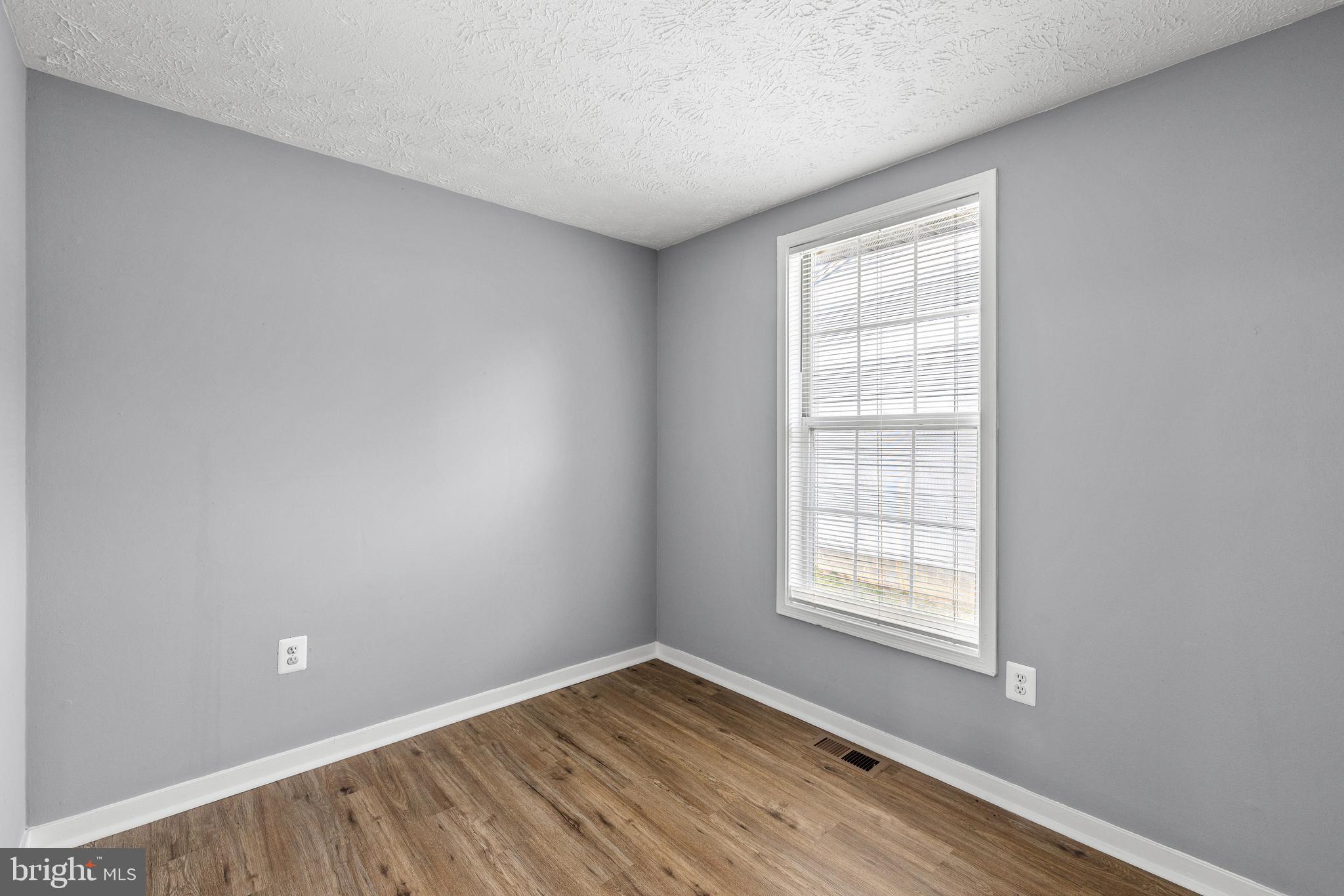 9479 Inaugural Drive King George, VA 22485 - Photo 13 of 26 an empty room with wooden floor and windows