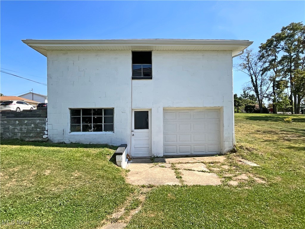 200 Ritchie Avenue Weirton, WV 26062 - Photo 24 of 30 Rear view of house featuring a garage and a lawn