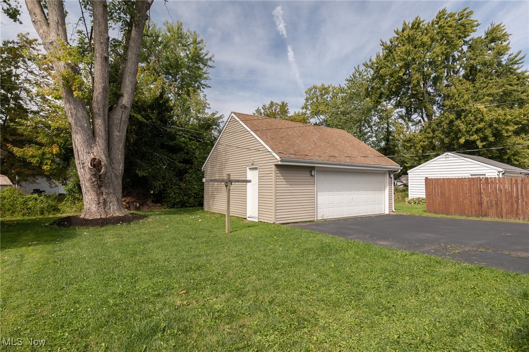 4782 Belle Meadow Road Mentor, OH 44060 - Photo 4 of 22 Garage featuring a lawn