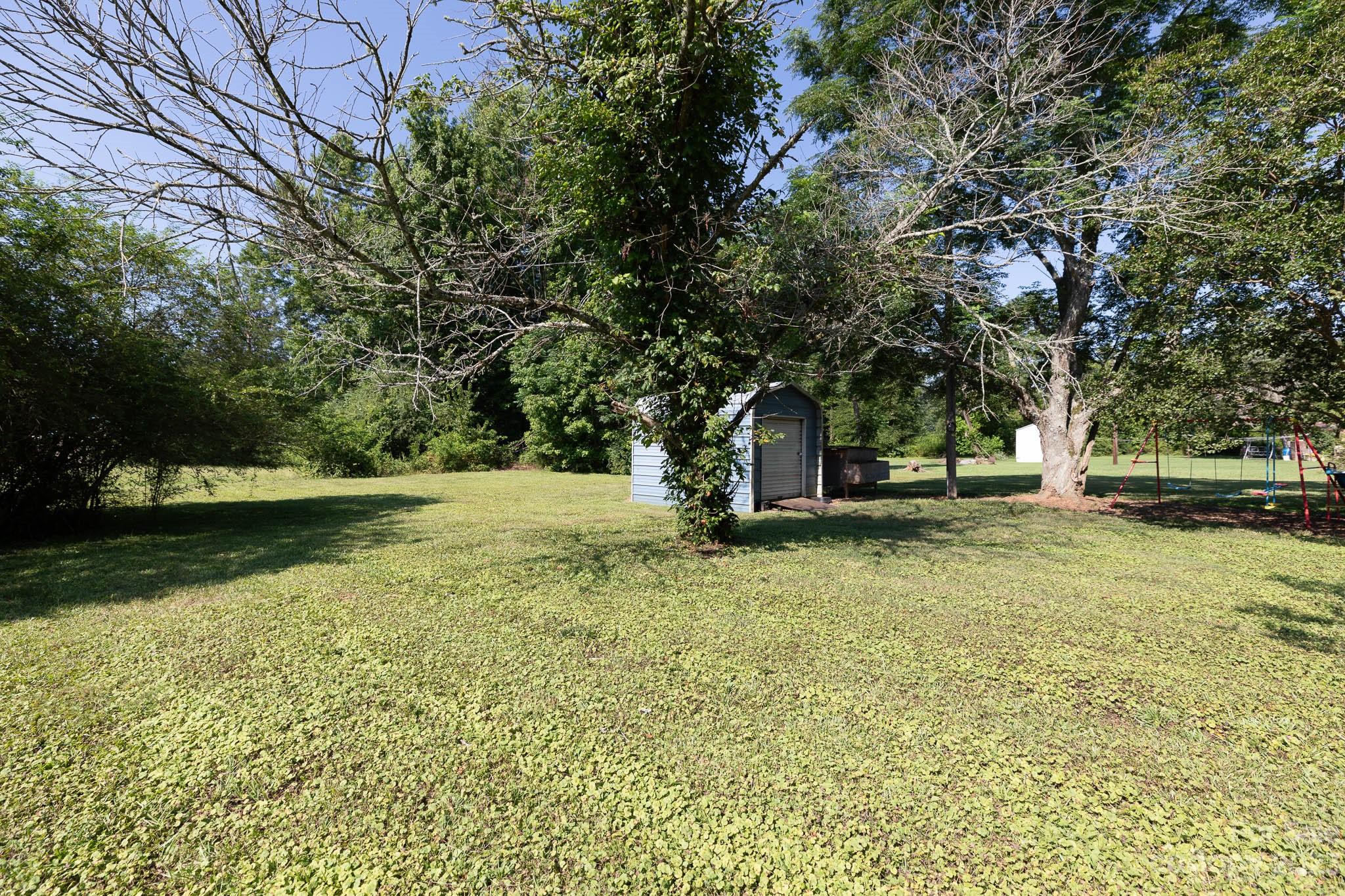 1494 Shiloh Unity Road Lancaster, SC 29720 - Photo 18 of 23 a view of a garden with large trees