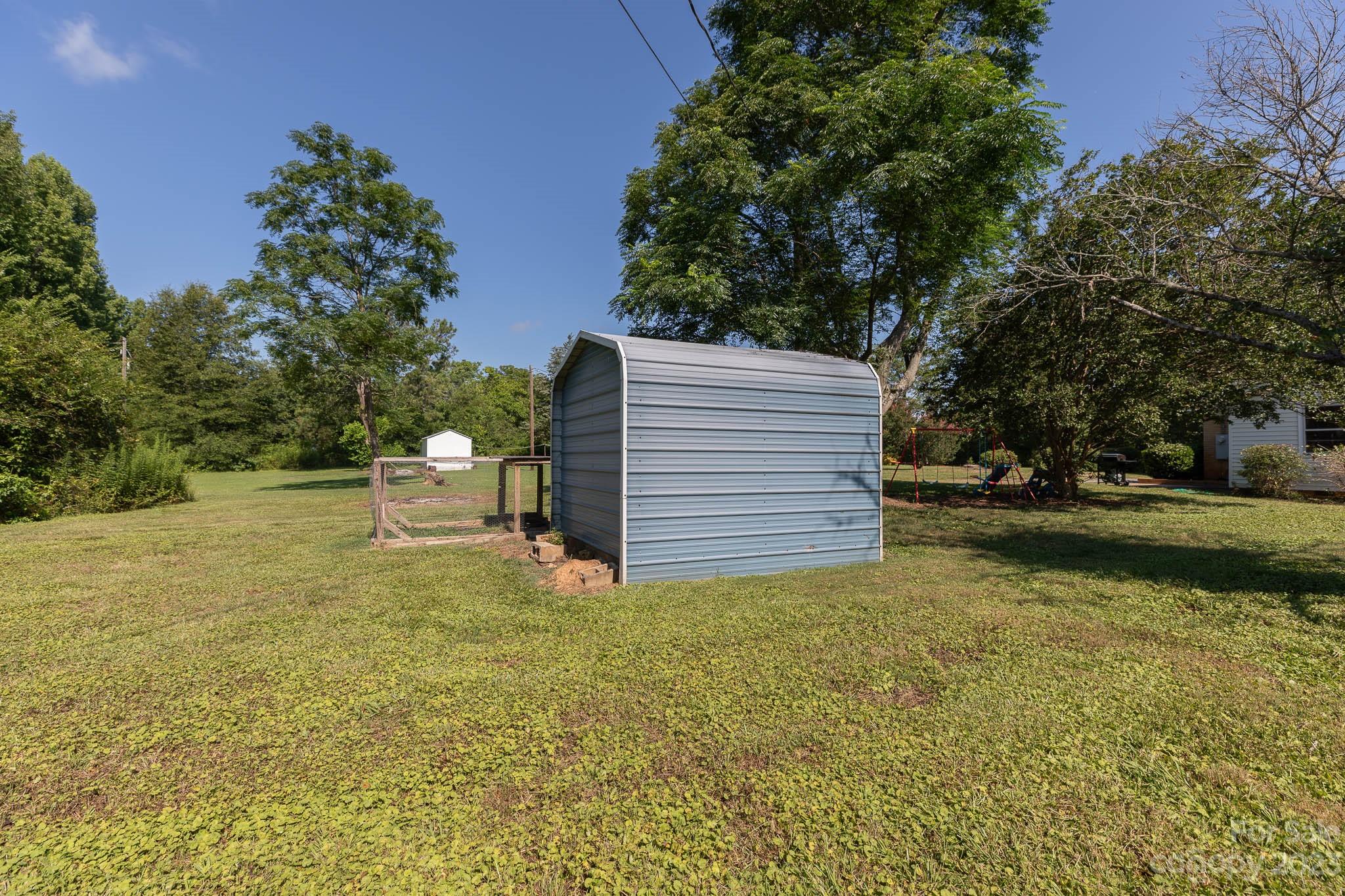 1494 Shiloh Unity Road Lancaster, SC 29720 - Photo 20 of 23 a view of a yard with plants and large trees
