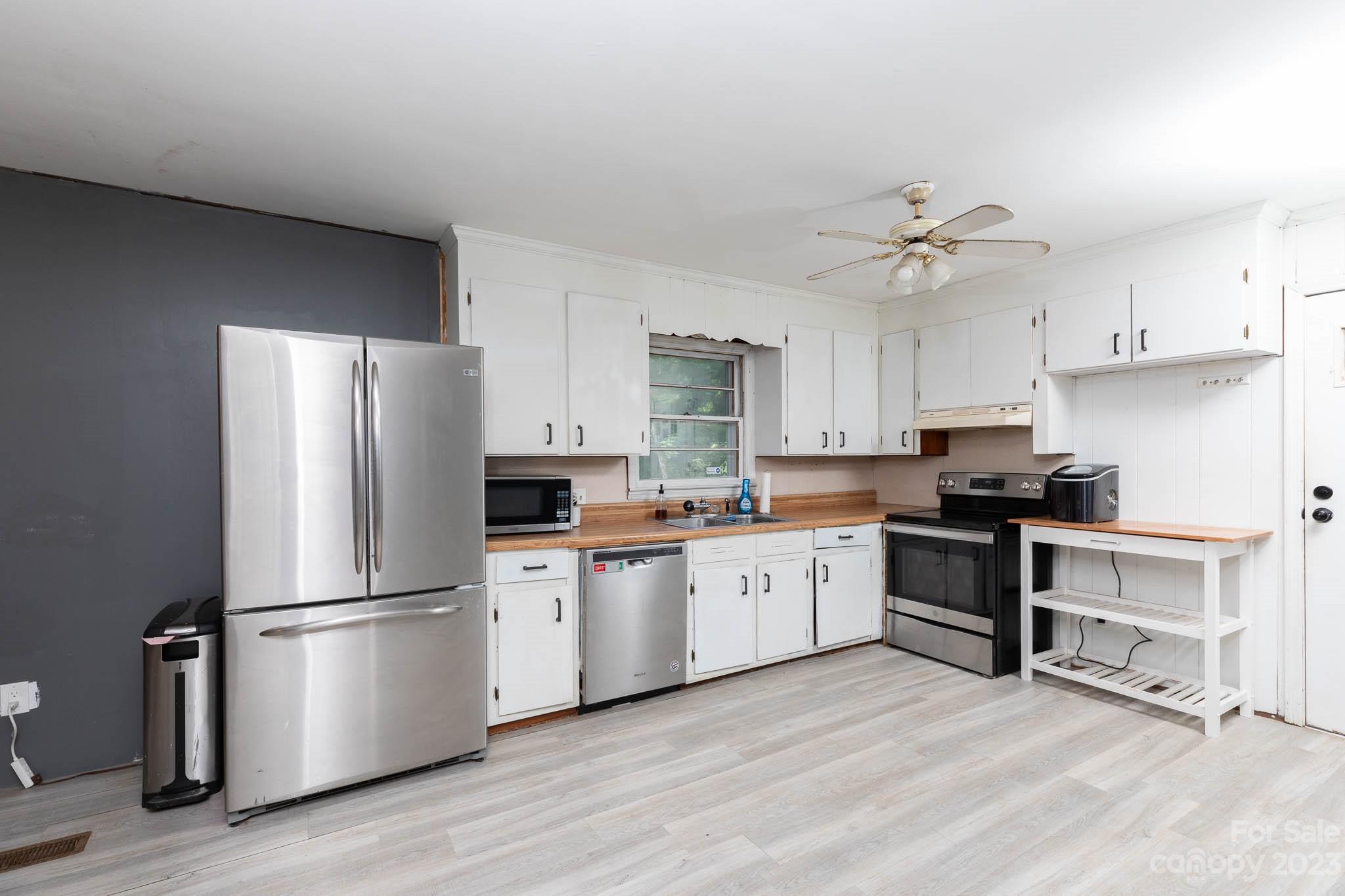 1494 Shiloh Unity Road Lancaster, SC 29720 - Photo 6 of 23 a kitchen with stainless steel appliances a refrigerator sink and cabinets