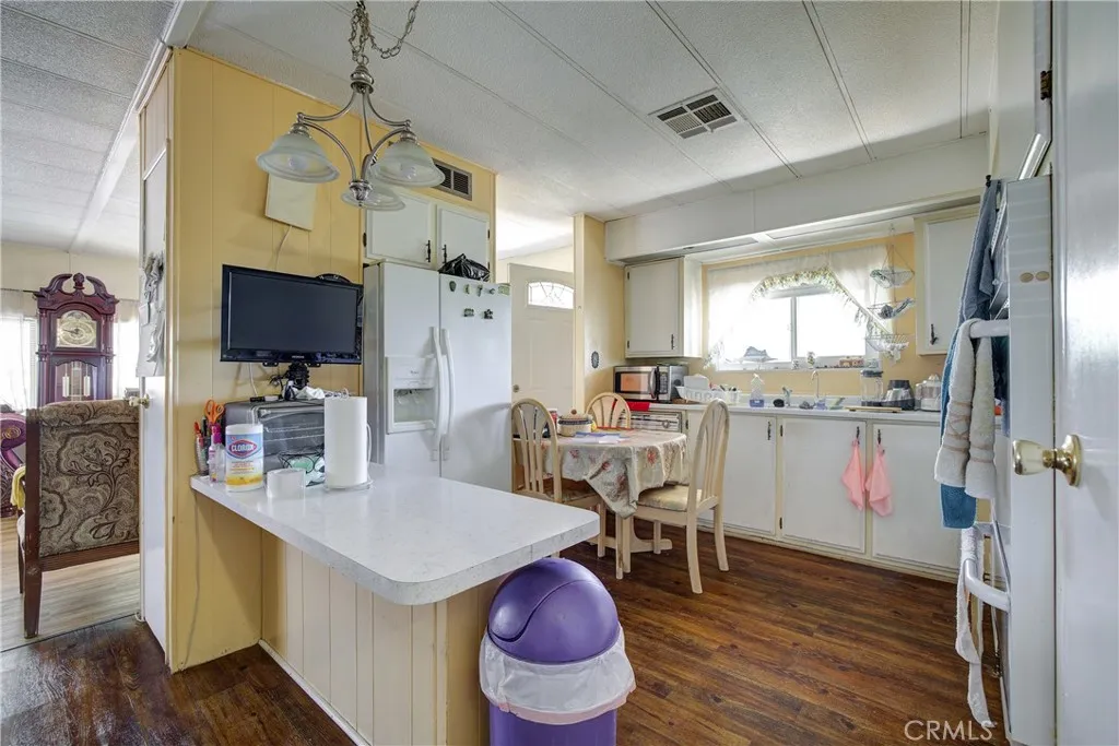 3700 Buchanan Street, Unit 180 Riverside, CA 92501 - Photo 13 of 23 a kitchen with stainless steel appliances kitchen island granite countertop a stove a sink and a refrigerator