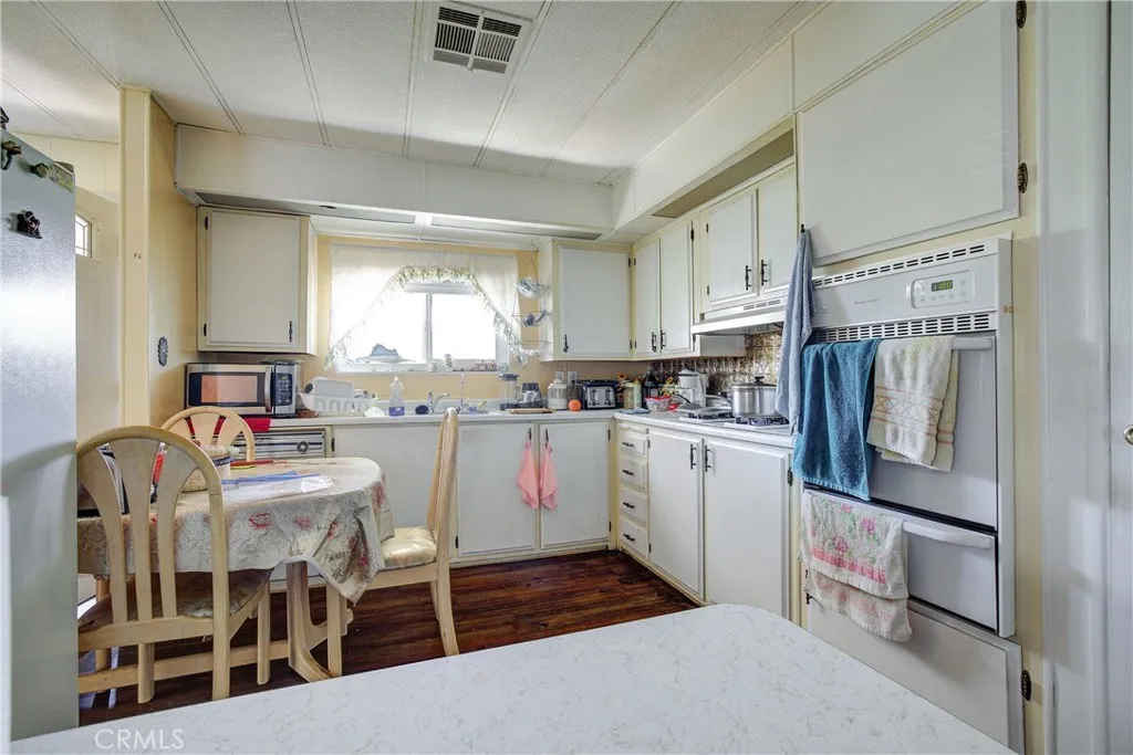 3700 Buchanan Street, Unit 180 Riverside, CA 92503 - Photo 14 of 23 a kitchen with lot of cabinets and refrigerator