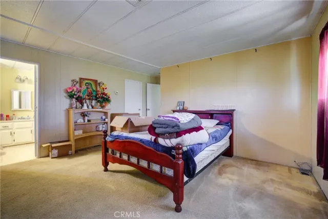 a bedroom with a bed and a table in it