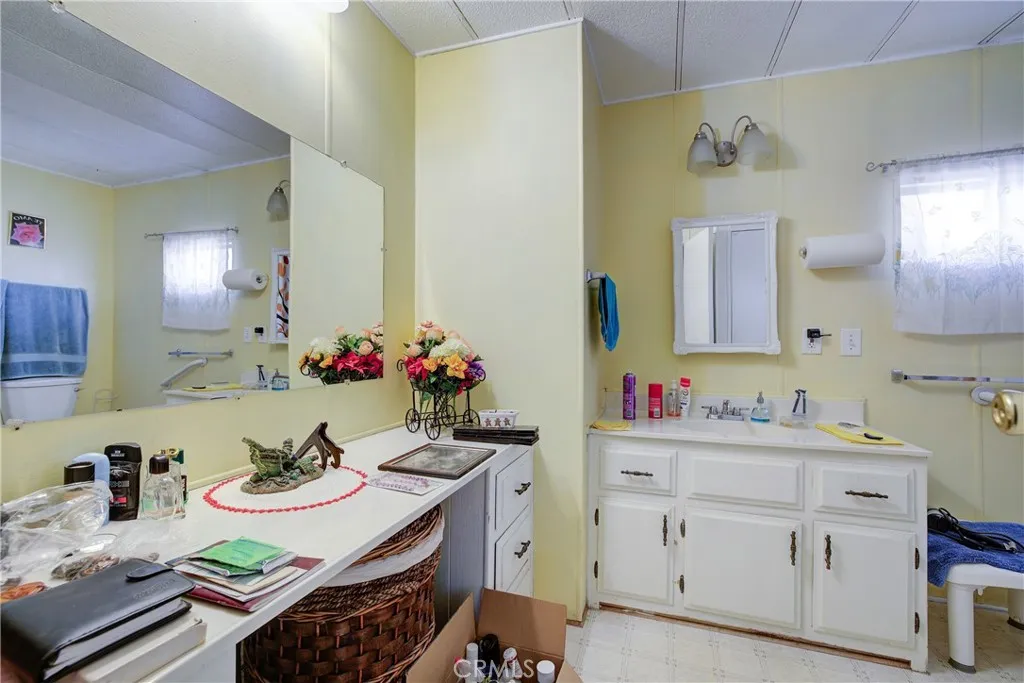 3700 Buchanan Street, Unit 180 Riverside, CA 92503 - Photo 18 of 23 a bathroom with a sink vanity granite and a mirror