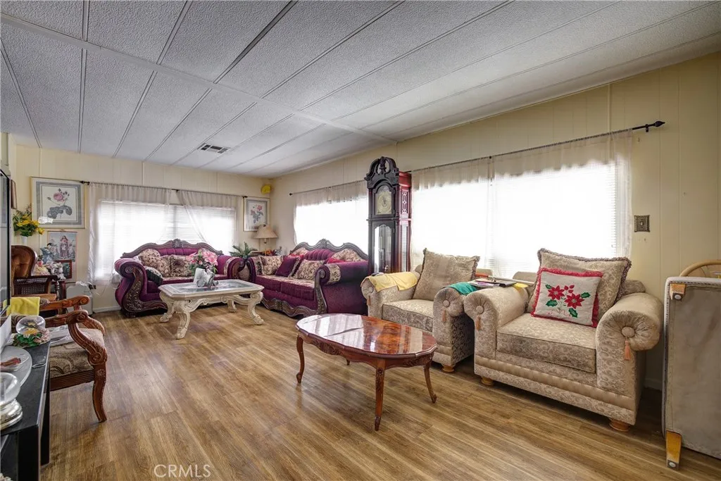3700 Buchanan Street, Unit 180 Riverside, CA 92503 - Photo 4 of 23 a living room with furniture a large window and wooden floor