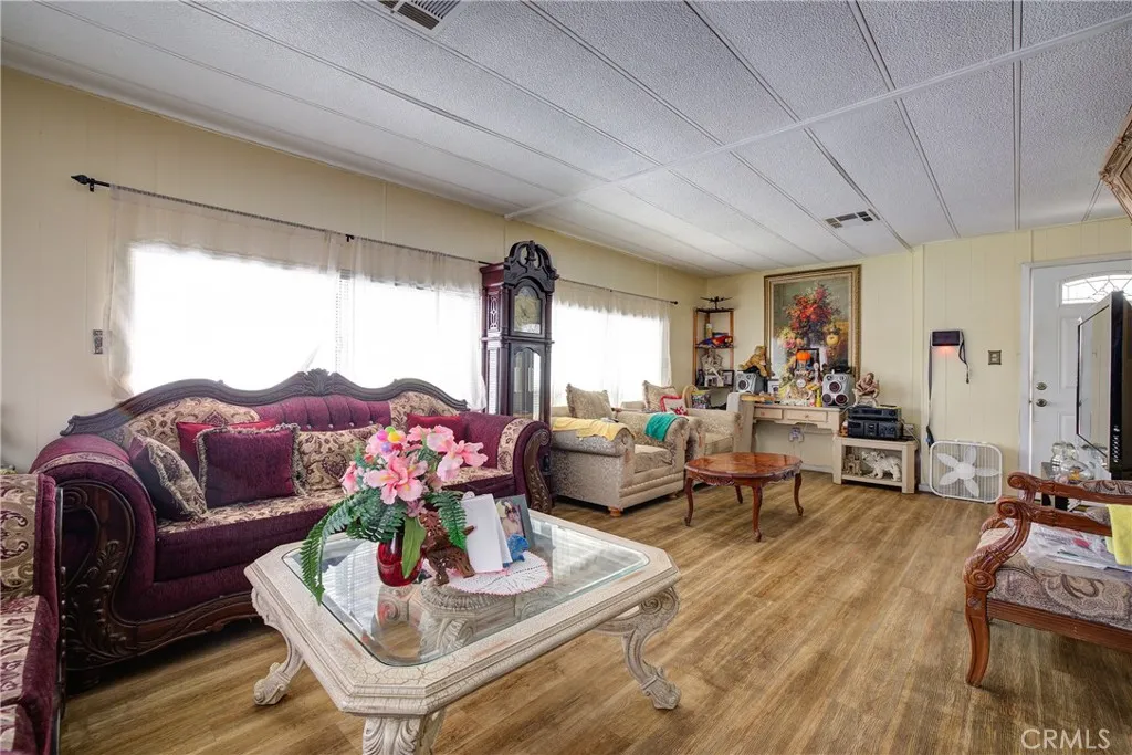 3700 Buchanan Street, Unit 180 Riverside, CA 92501 - Photo 5 of 23 a living room with furniture potted plant and a large window