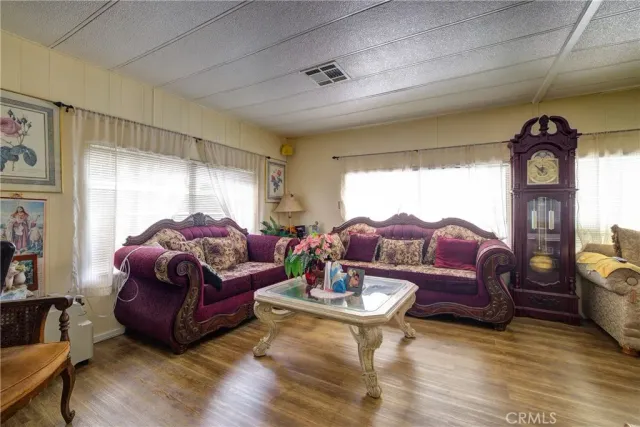 a living room with furniture a rug and a large window
