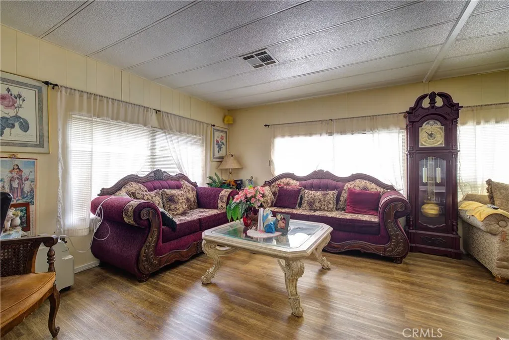 3700 Buchanan Street, Unit 180 Riverside, CA 92501 - Photo 9 of 23 a living room with furniture a rug and a large window