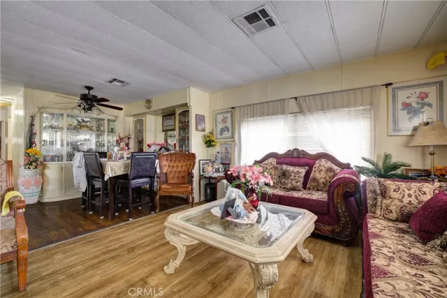 a living room with furniture and a dining table