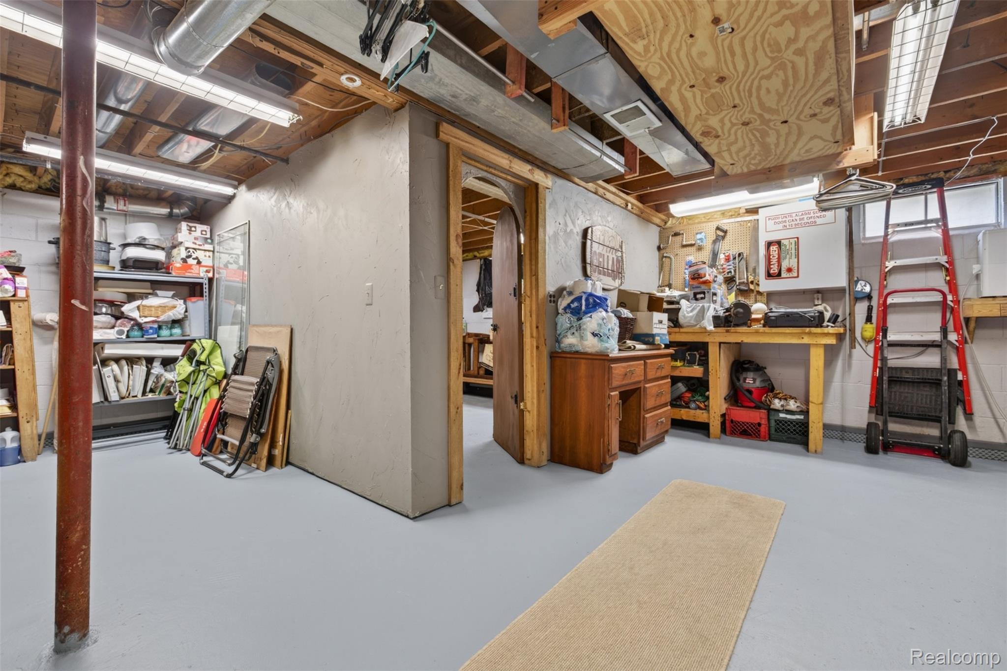 5977 Anglers Road Ortonville, MI 48462 - Photo 30 of 63 Basement area with light gray flooring and exposed ceiling beams
