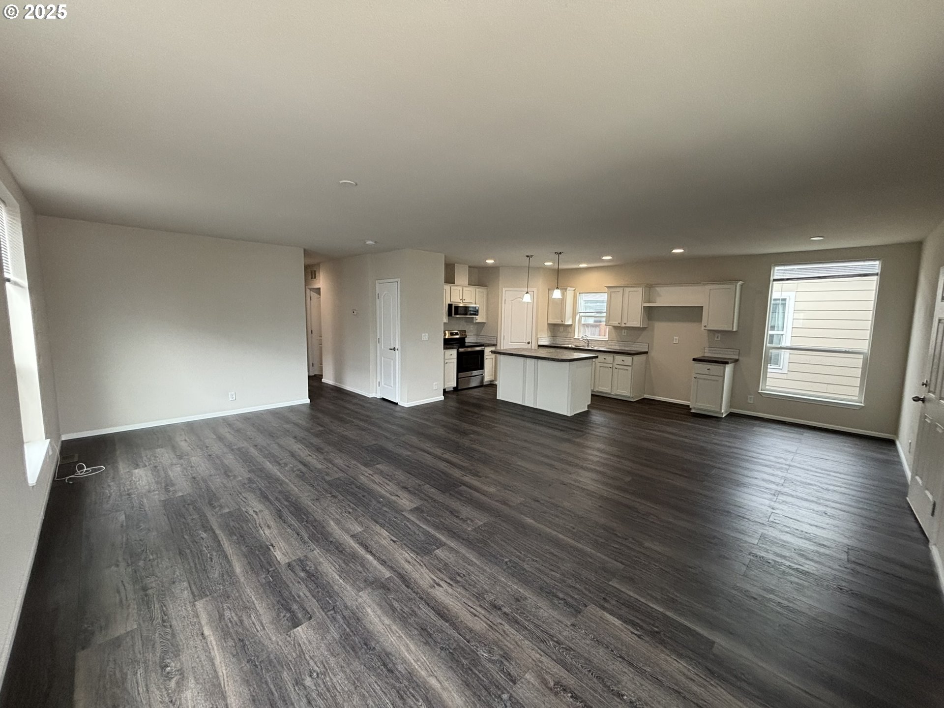 5270 Nopal Street Florence, OR 97439 - Photo 10 of 27 an empty room with wooden floor kitchen view and a window