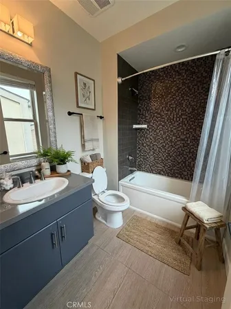 a bathroom with a granite countertop sink toilet a mirror and bathtub
