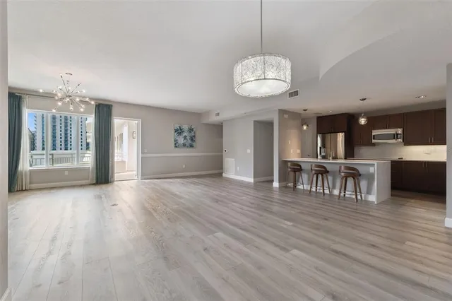 a view of a kitchen and an empty room