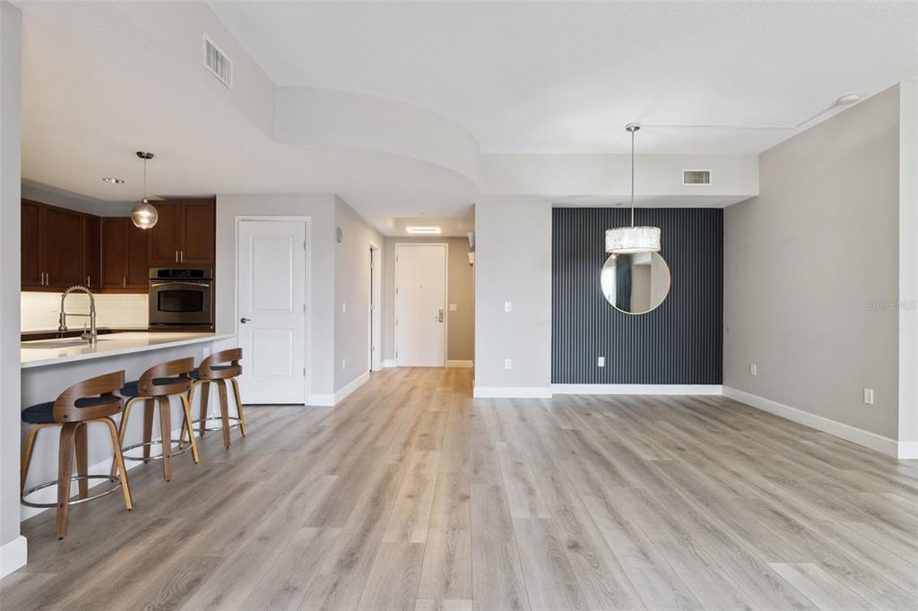 100 South Eola Drive, Unit 911 Orlando, FL 32801 - Photo 14 of 53 a view of a kitchen with furniture and wooden floor