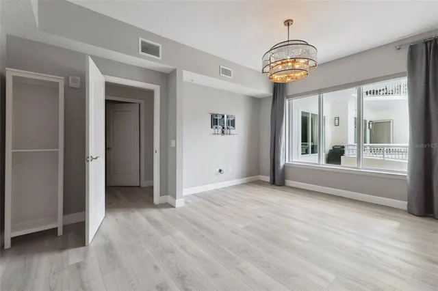 a view of an empty room with wooden floor