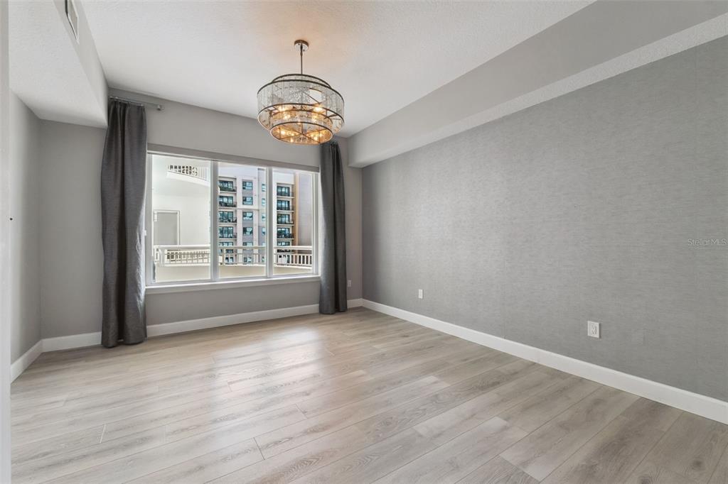 100 South Eola Drive, Unit 911 Orlando, FL 32801 - Photo 22 of 53 an empty room with wooden floor and windows