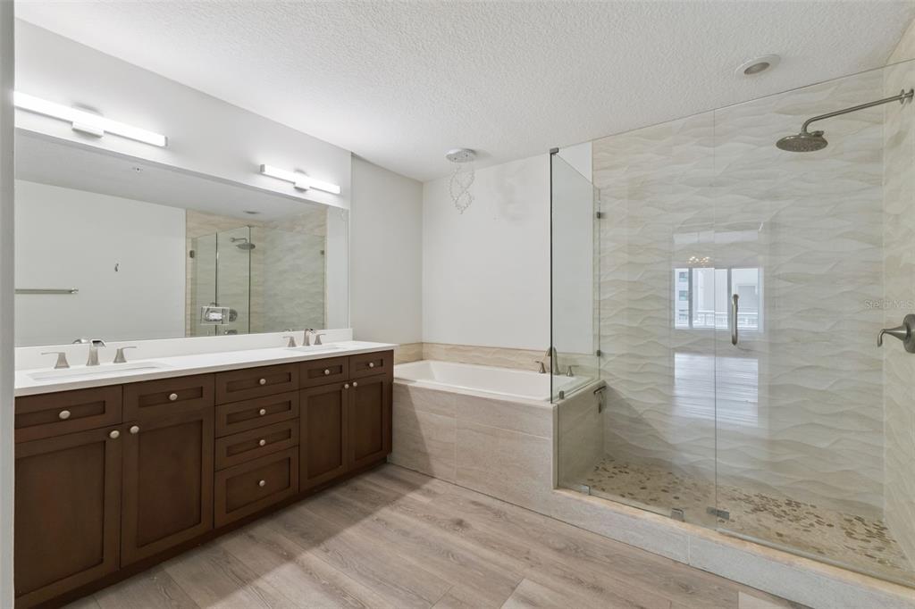 100 South Eola Drive, Unit 911 Orlando, FL 32801 - Photo 28 of 53 a spacious bathroom with a double vanity sink mirror and shower