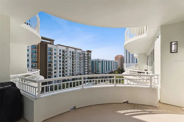 a view of swimming pool with outdoor seating and buildings in the background