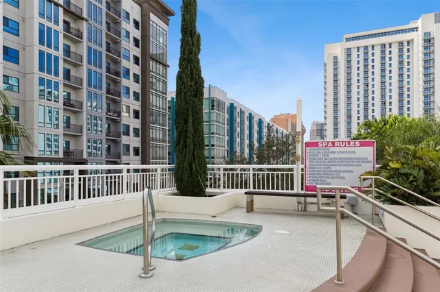 a roof deck with couches and potted plants