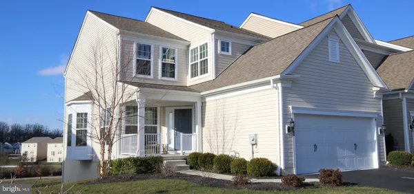 a view of a house with brick walls and a yard
