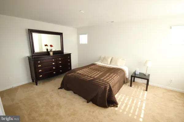 a bedroom with a bed and a dresser