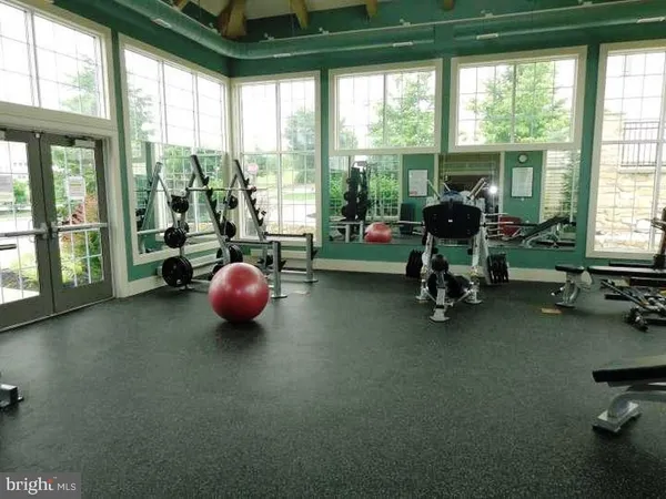 a view of a room with gym equipment and floor to ceiling window