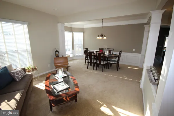a dining room with furniture and window