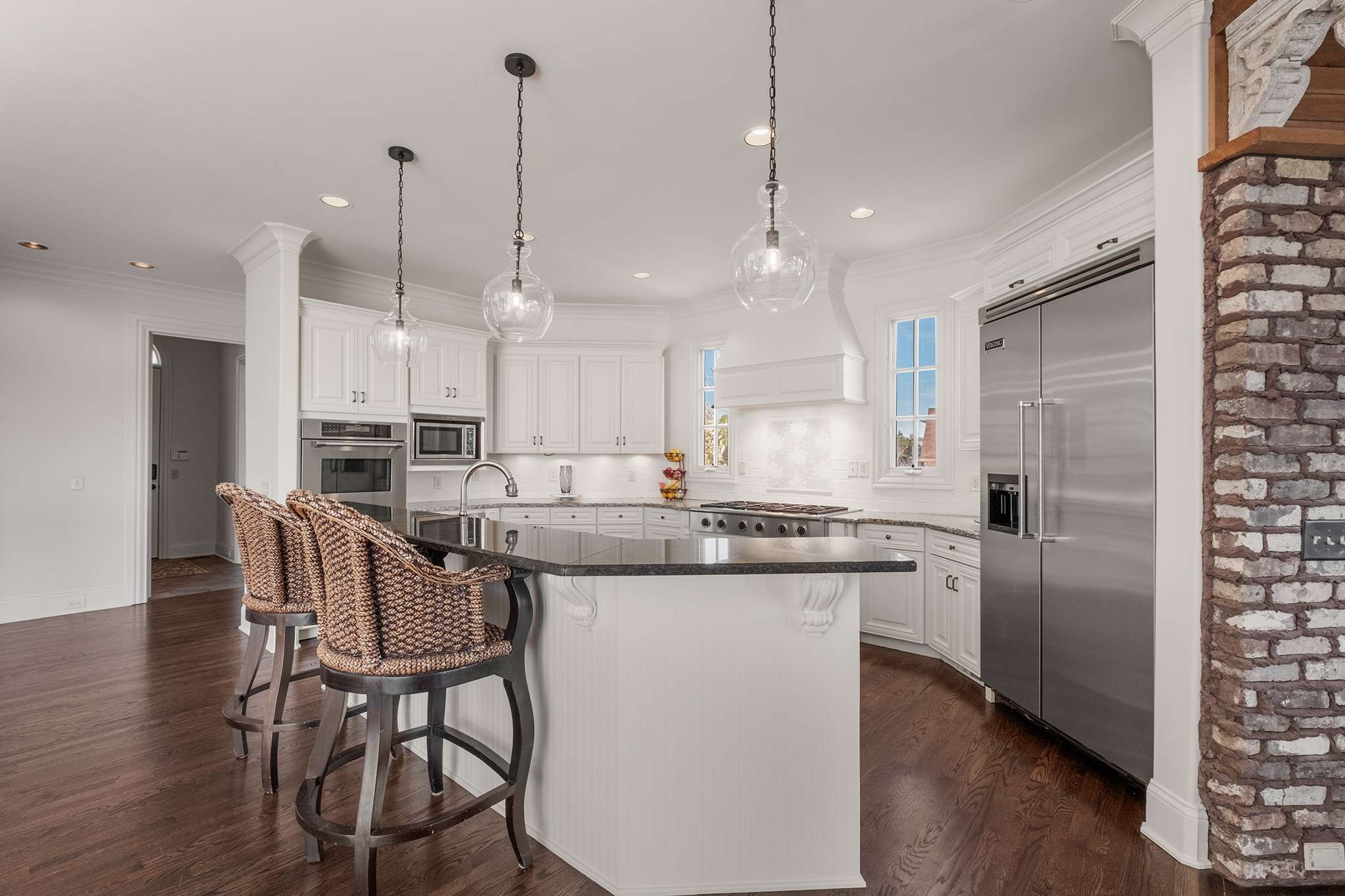 673 Legends Crest Drive Franklin, TN 37069 - Photo 19 of 81 a kitchen with kitchen island a dining table chairs sink and cabinets