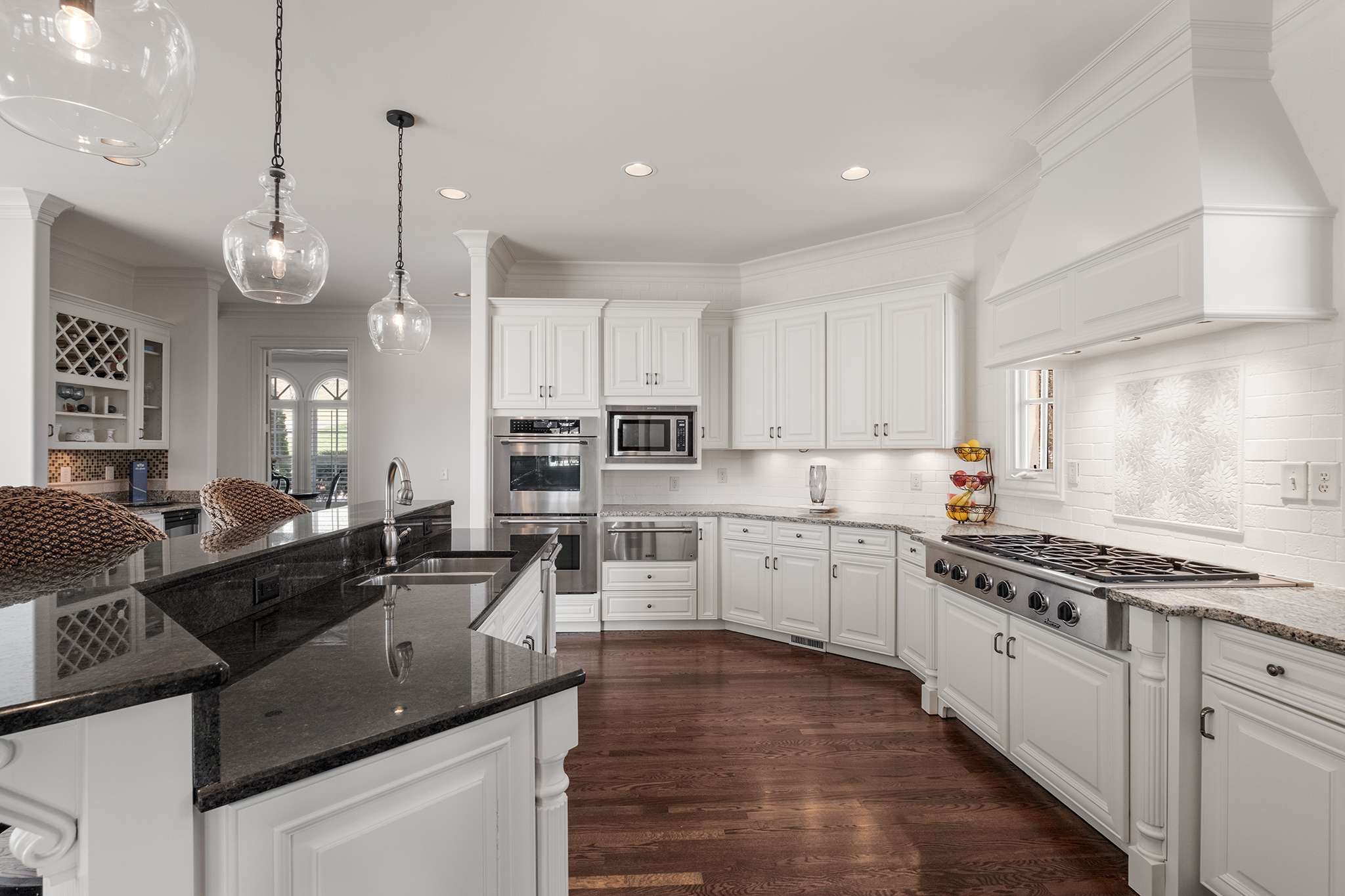673 Legends Crest Drive Franklin, TN 37069 - Photo 20 of 81 a kitchen with stainless steel appliances granite countertop a stove a sink a refrigerator and white cabinets with wooden floor