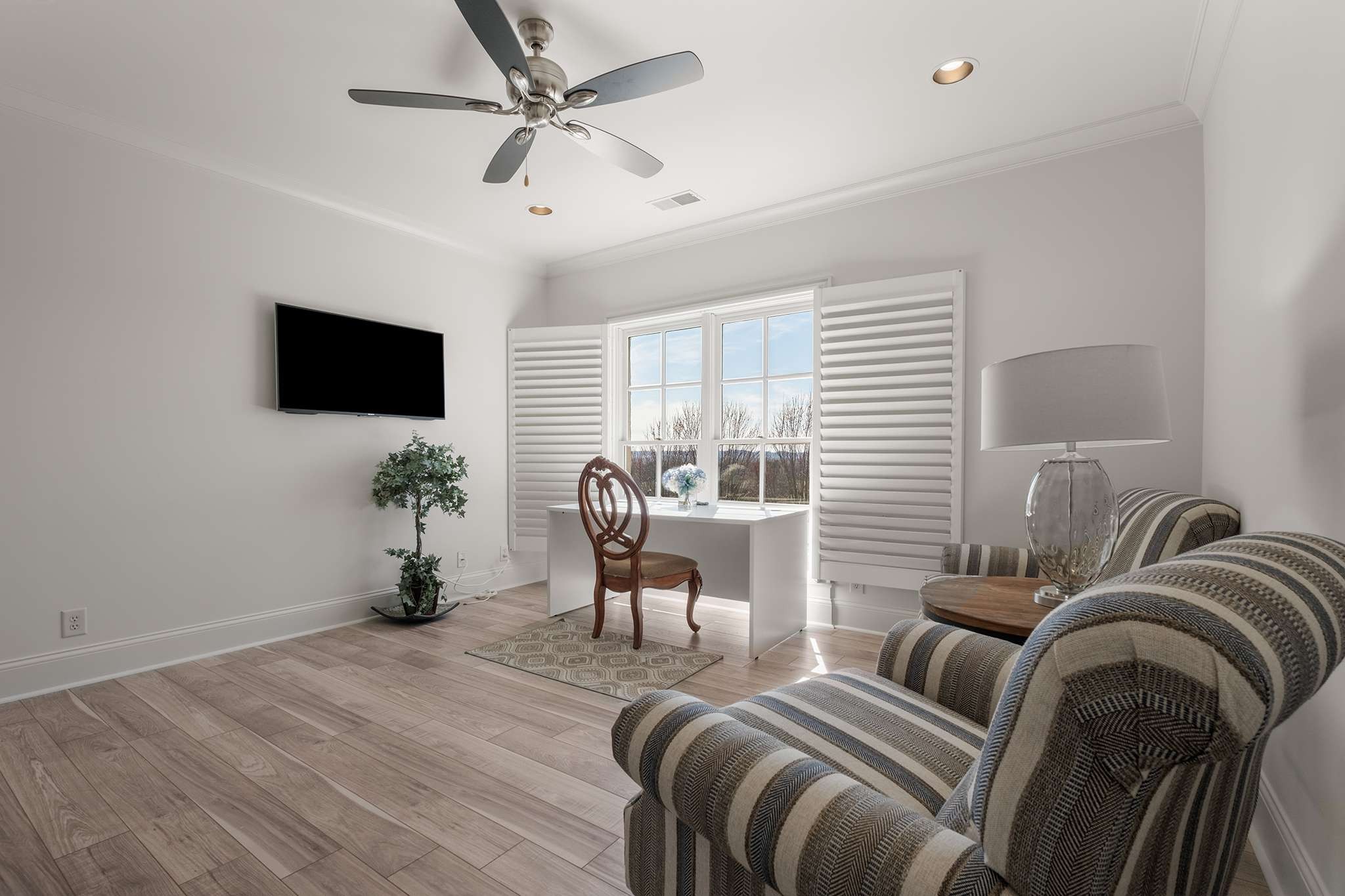 673 Legends Crest Drive Franklin, TN 37069 - Photo 42 of 81 a living room with furniture a ceiling fan and a flat screen tv