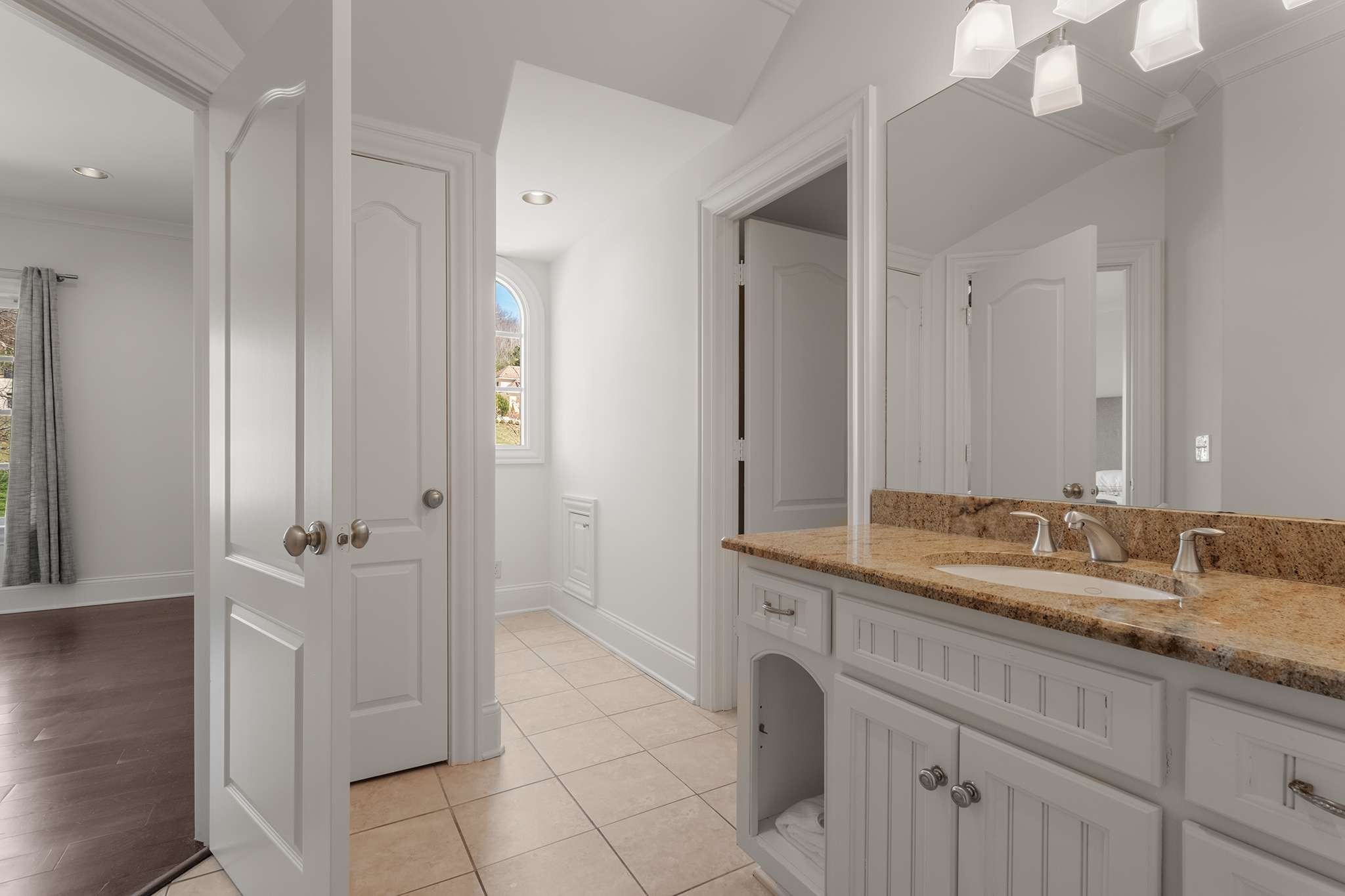 673 Legends Crest Drive Franklin, TN 37069 - Photo 47 of 81 a bathroom with a granite countertop sink a mirror and a shower