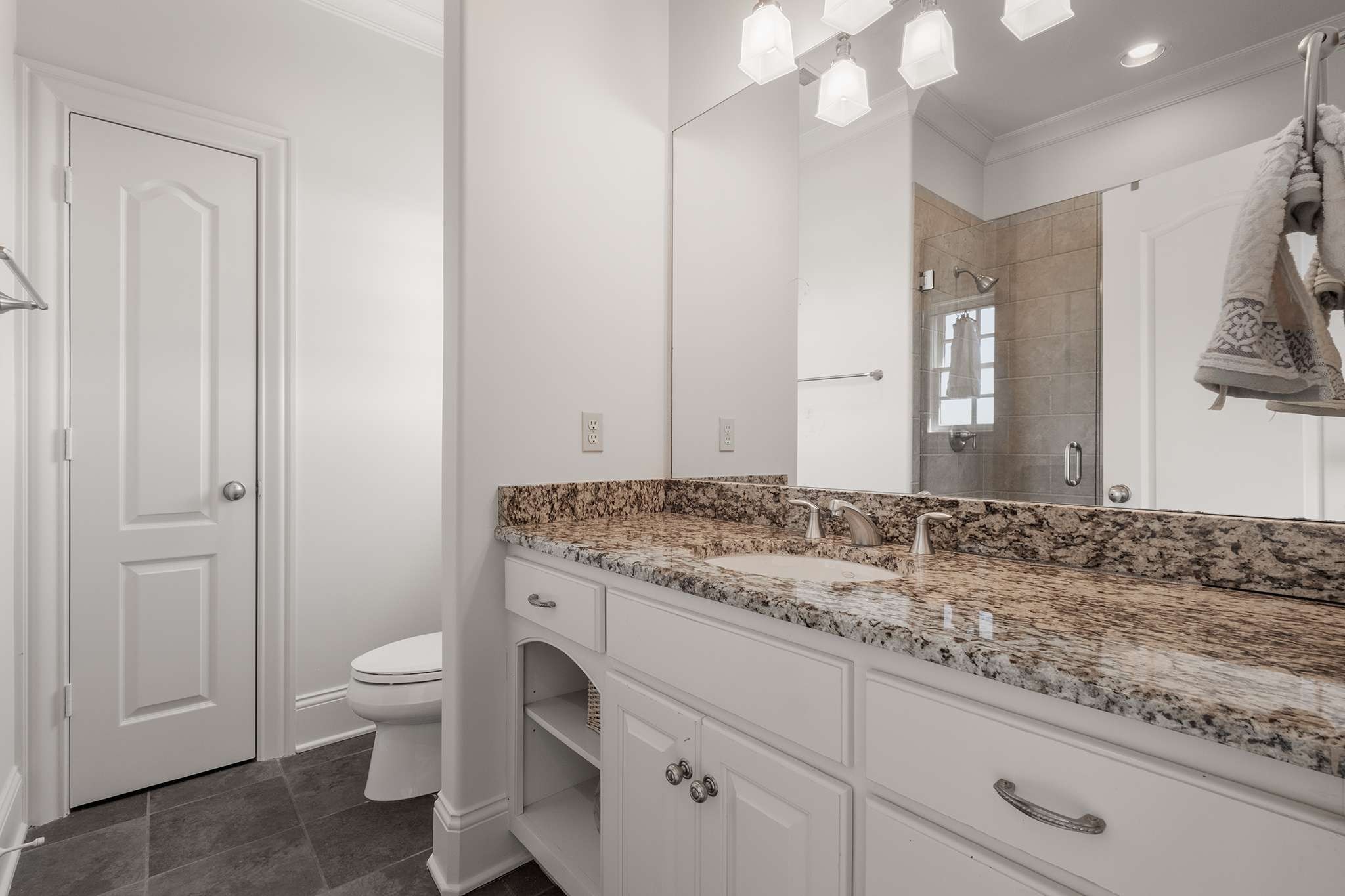 673 Legends Crest Drive Franklin, TN 37069 - Photo 50 of 81 a bathroom with a granite countertop sink and a toilet