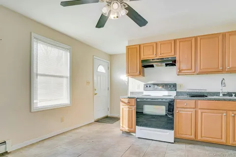 a kitchen with stainless steel appliances granite countertop a sink a stove a microwave and cabinets