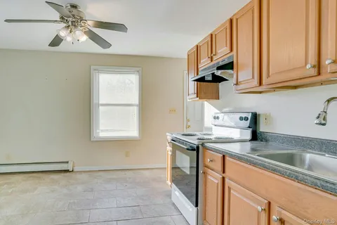 a view of a kitchen with a sink and cabinet