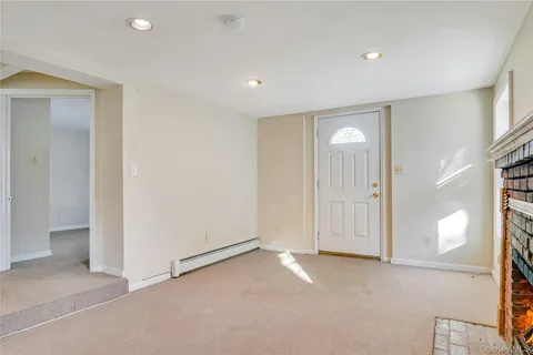 a view of empty room with kitchen
