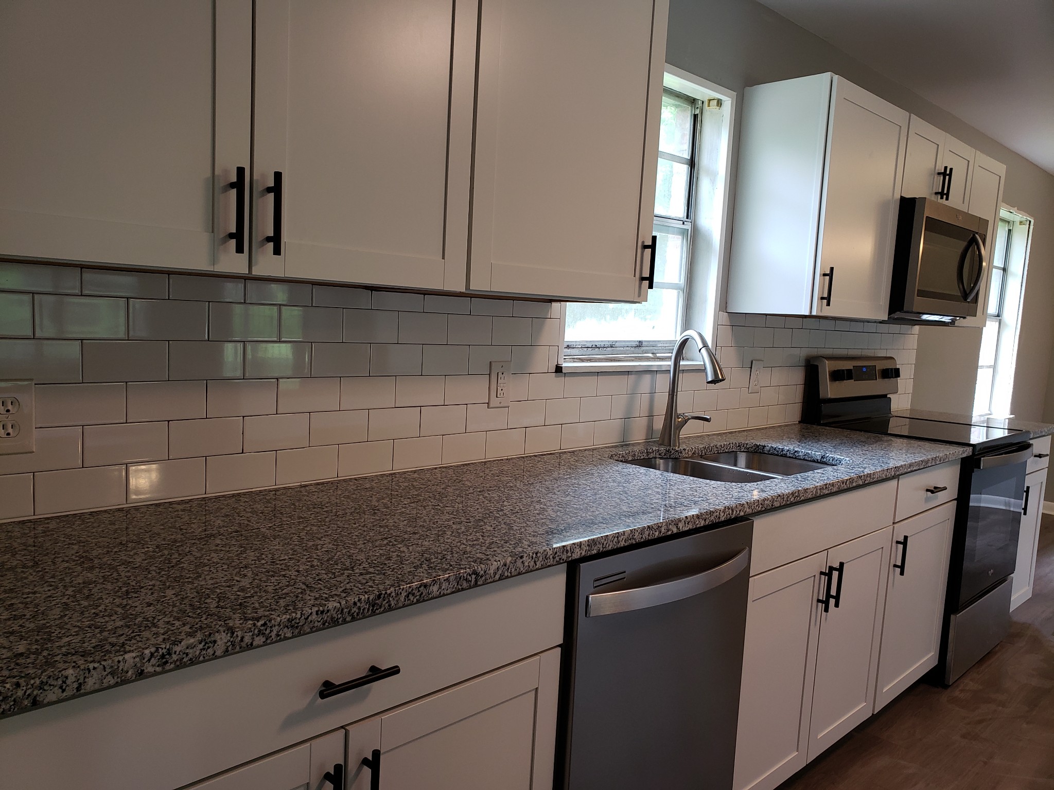 814 Miles Road Pulaski, TN 38478 - Photo 12 of 35 a kitchen with stainless steel appliances granite countertop a sink stove and microwave