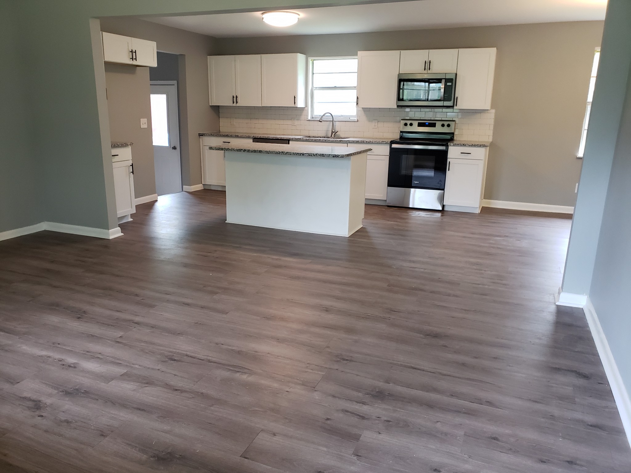 814 Miles Road Pulaski, TN 38478 - Photo 6 of 35 a kitchen with stainless steel appliances wooden floors and wooden cabinets