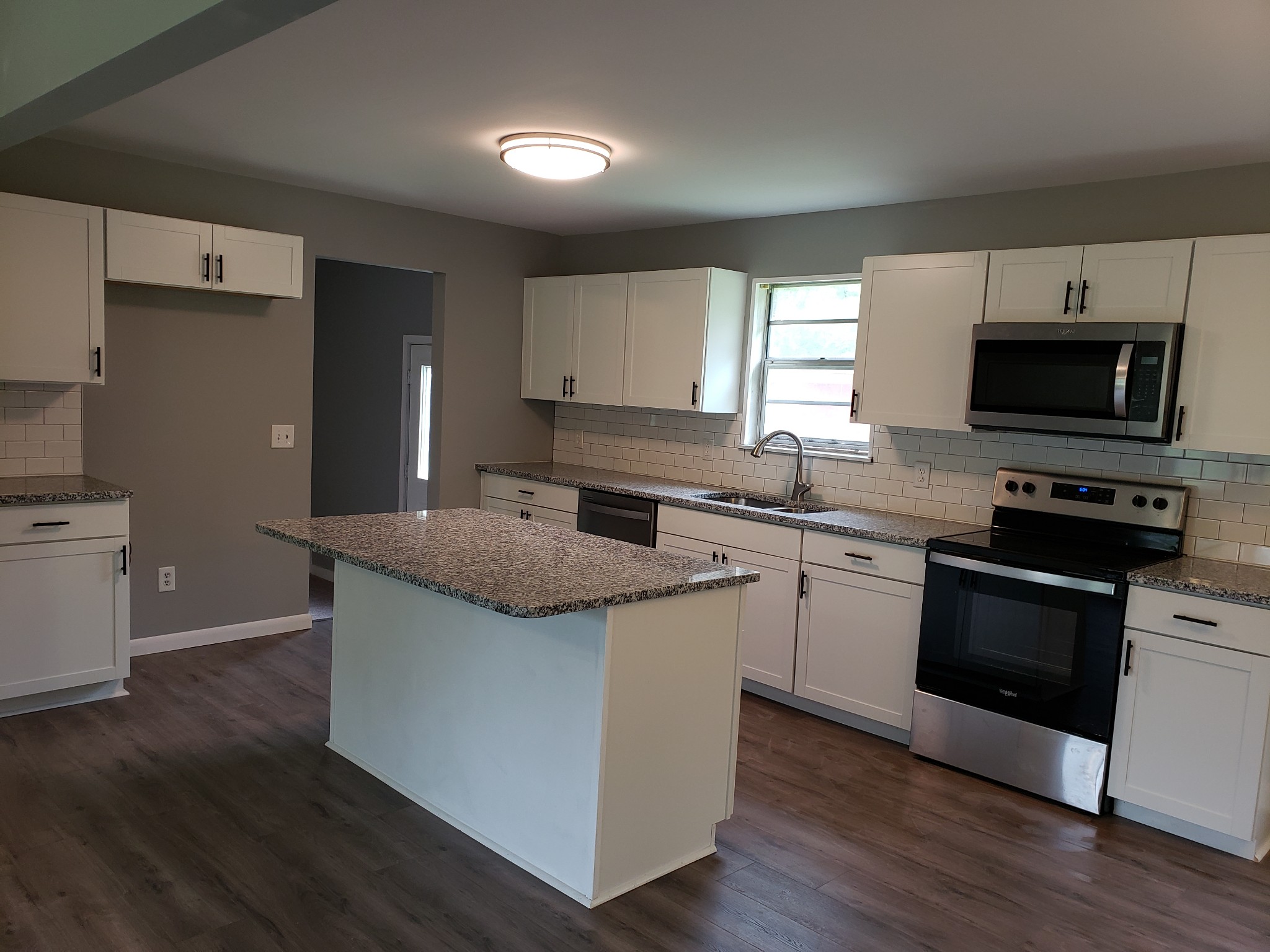 814 Miles Road Pulaski, TN 38478 - Photo 10 of 35 a kitchen with granite countertop a sink and steel appliances