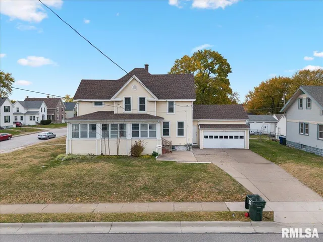 a view of a house with a yard and sitting area