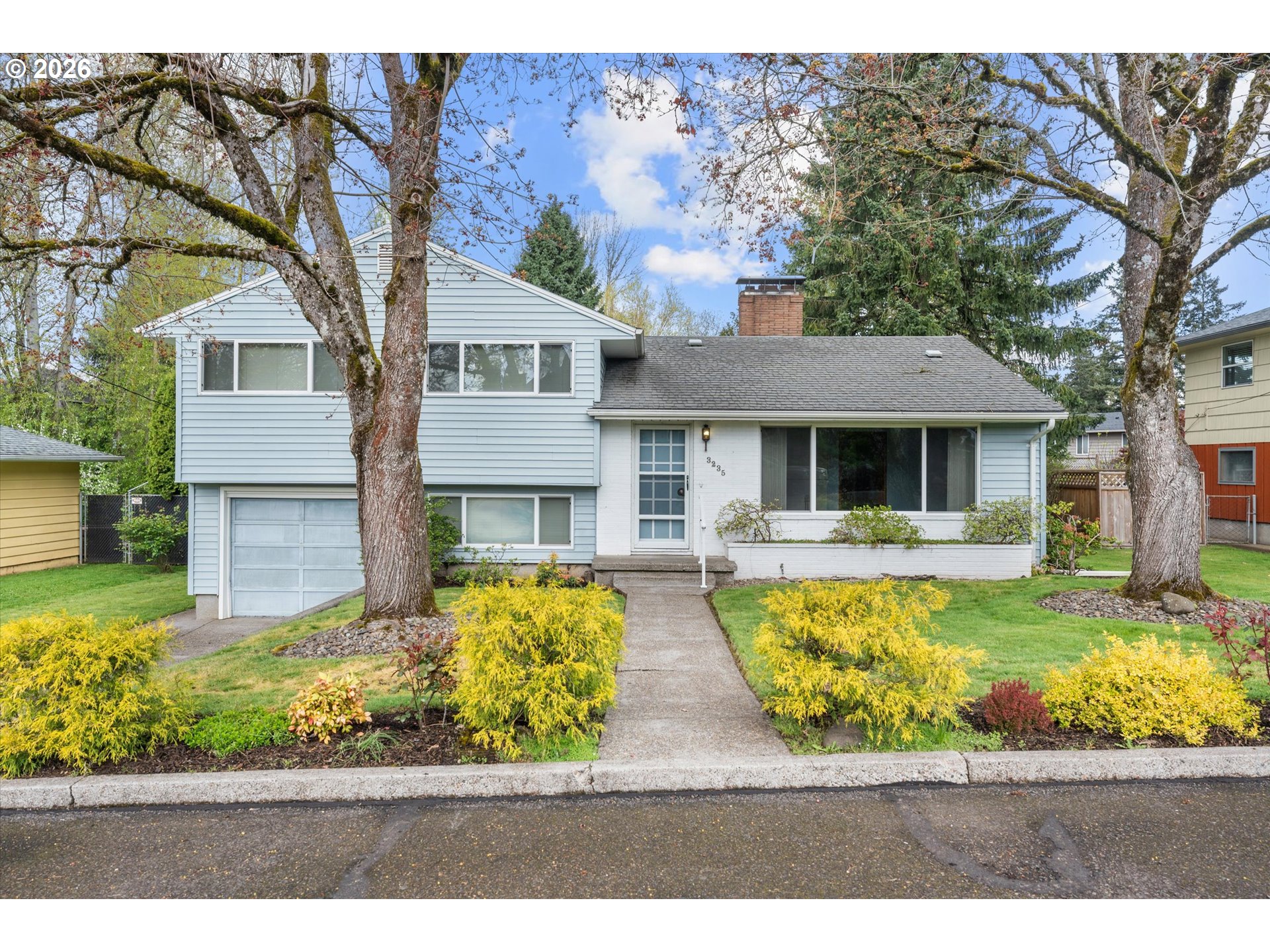 3235 Southeast Silver Springs Road Milwaukie, OR 97222 - Photo 1 of 32 a front view of a house with a yard table and chairs
