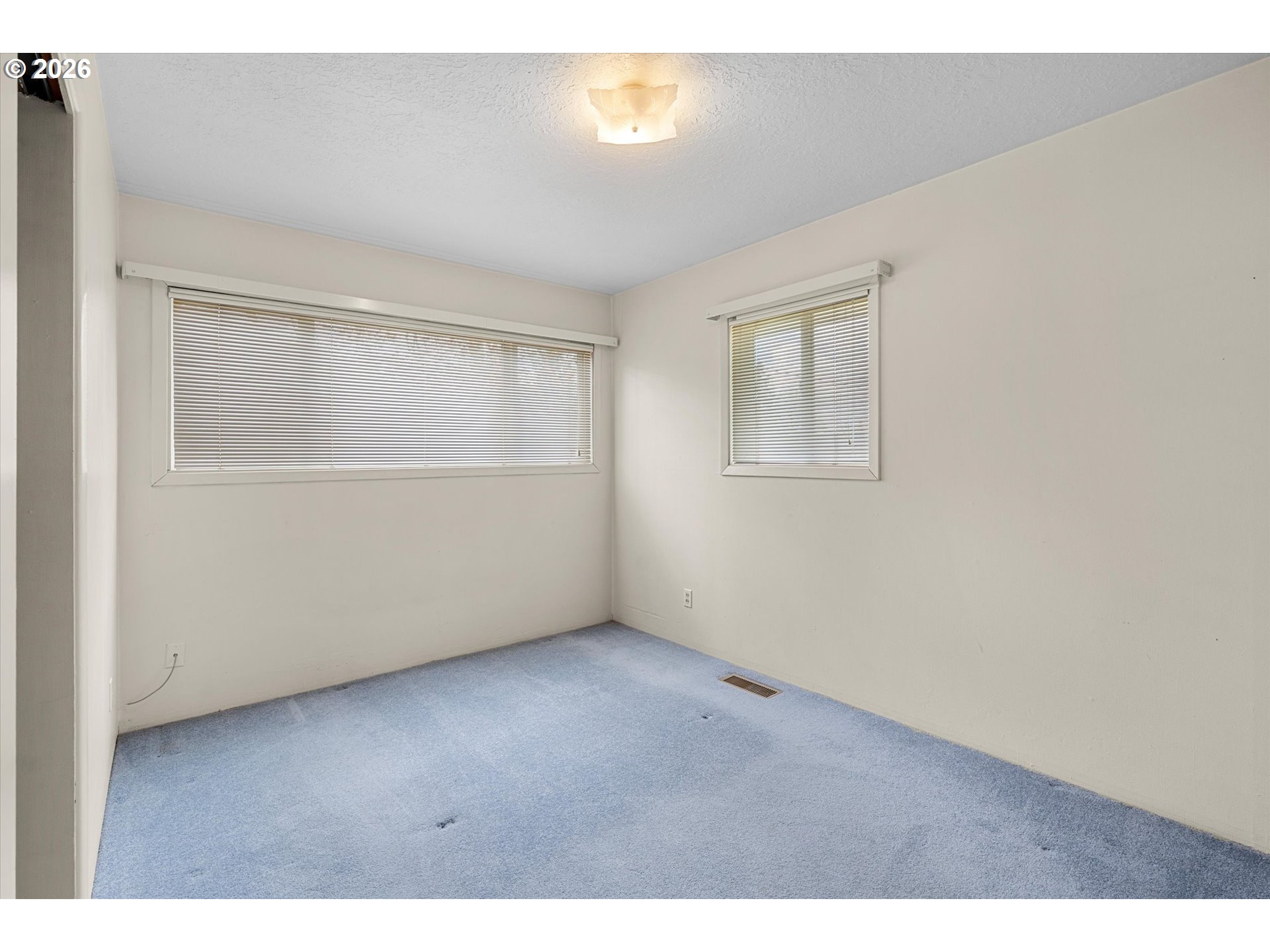 3235 Southeast Silver Springs Road Milwaukie, OR 97222 - Photo 17 of 32 an empty room with wooden floor and windows