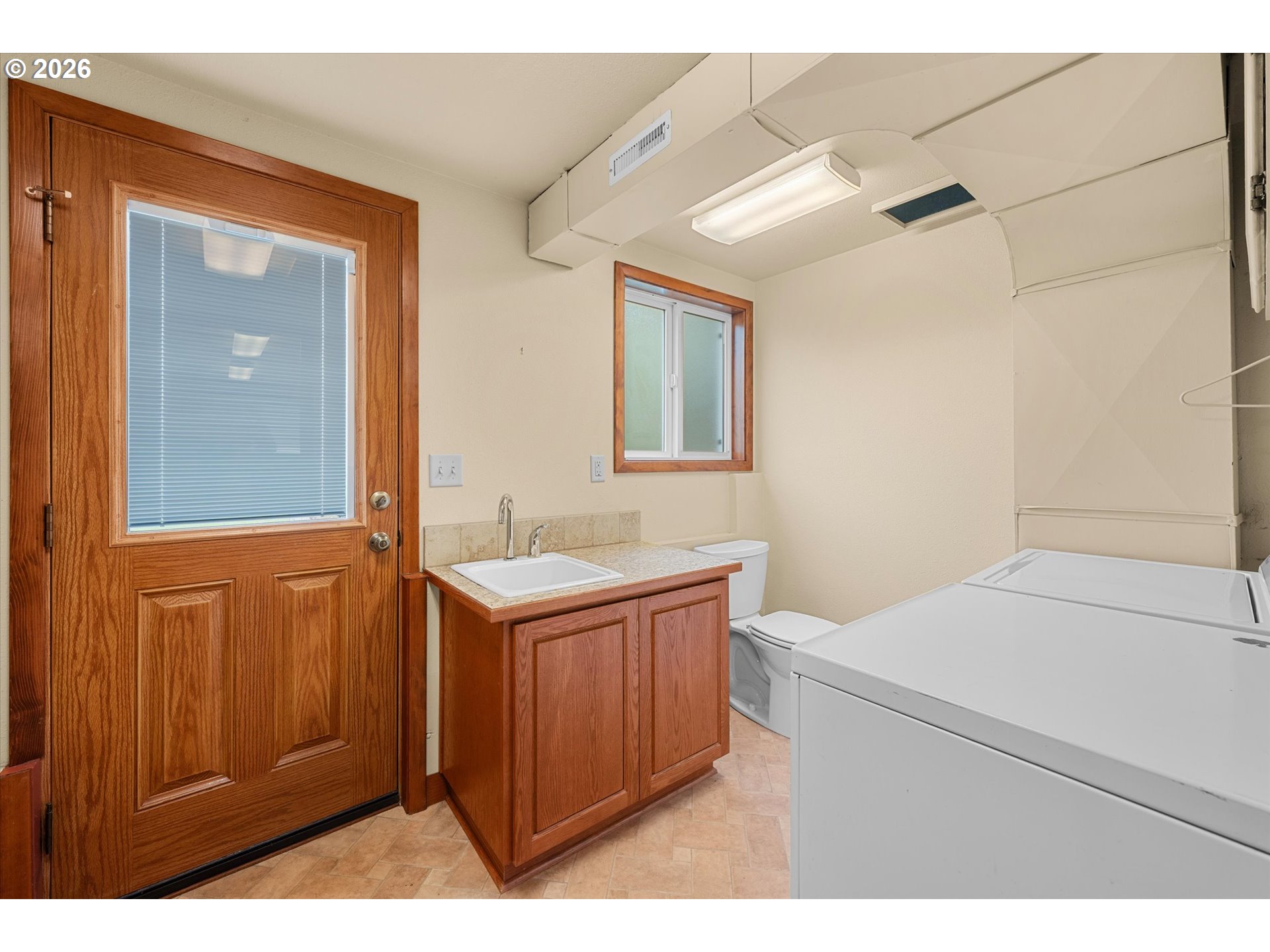 3235 Southeast Silver Springs Road Milwaukie, OR 97222 - Photo 23 of 32 a utility room with a sink a washer and dryer