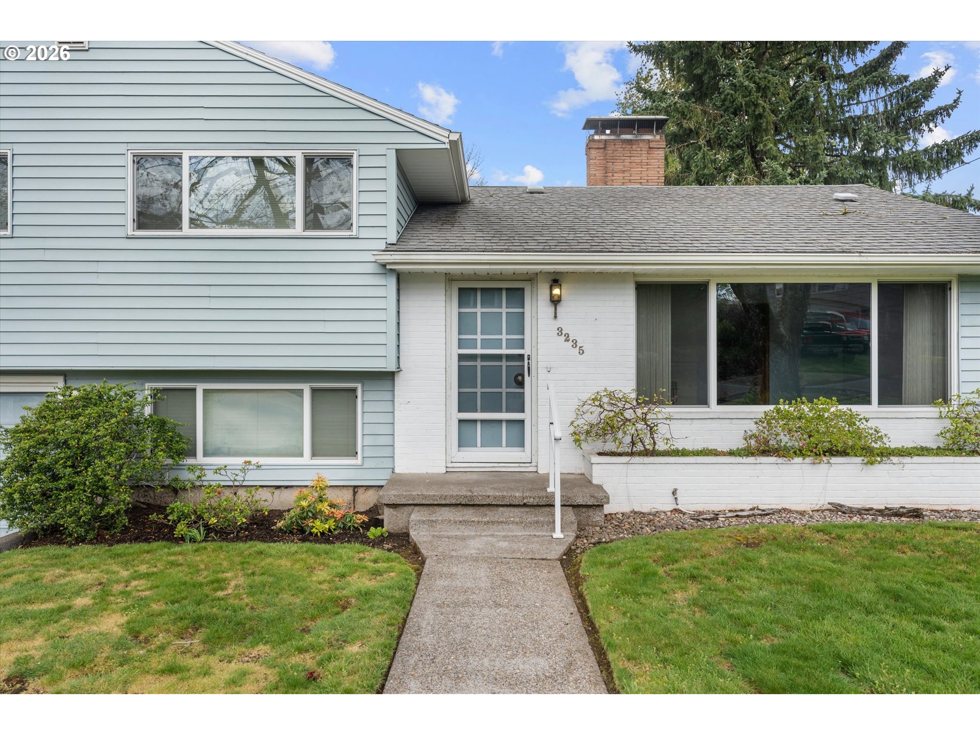 3235 Southeast Silver Springs Road Milwaukie, OR 97222 - Photo 3 of 32 a front view of a house with a yard