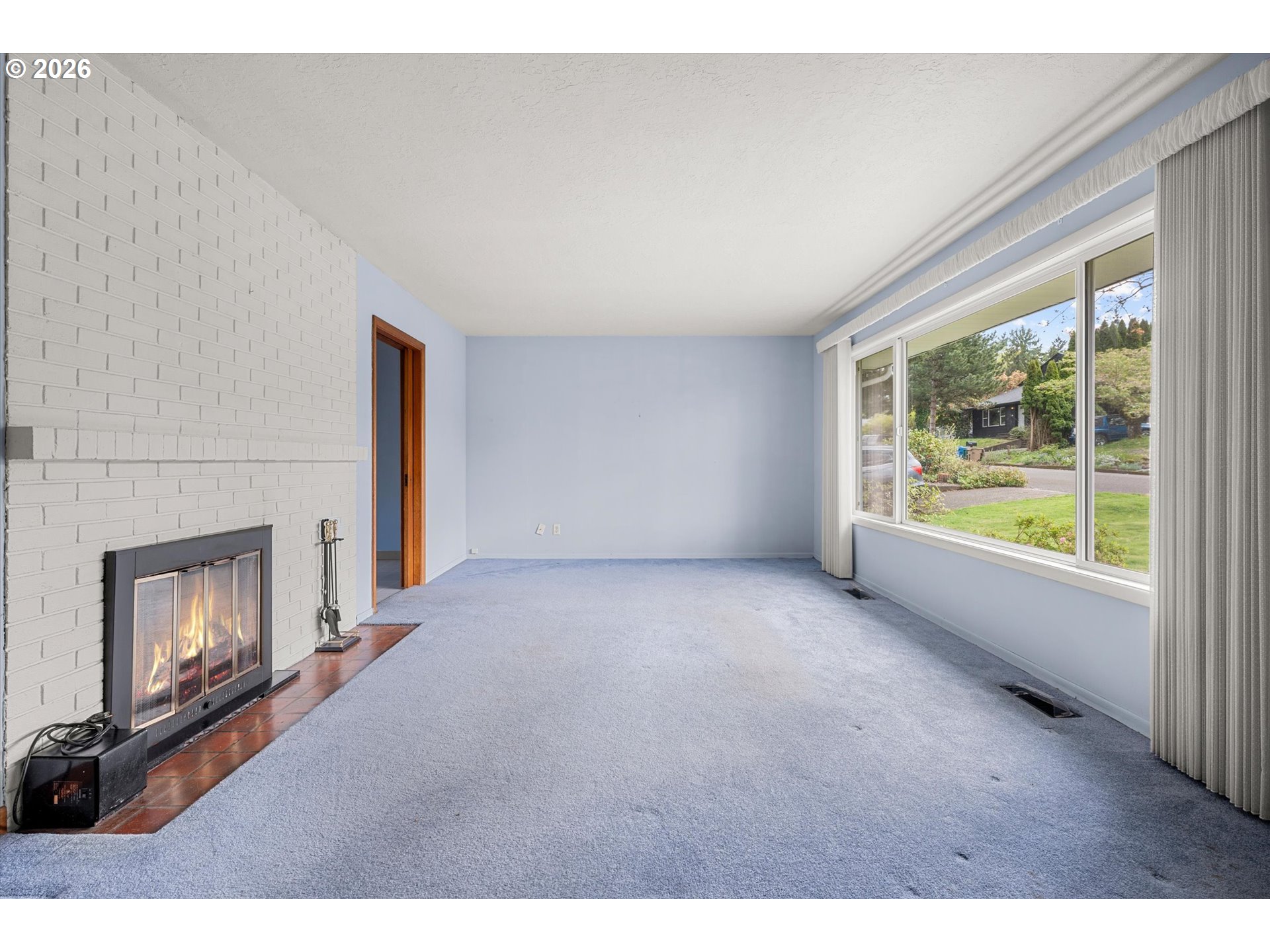 3235 Southeast Silver Springs Road Milwaukie, OR 97222 - Photo 5 of 32 a view of empty room with fireplace and window