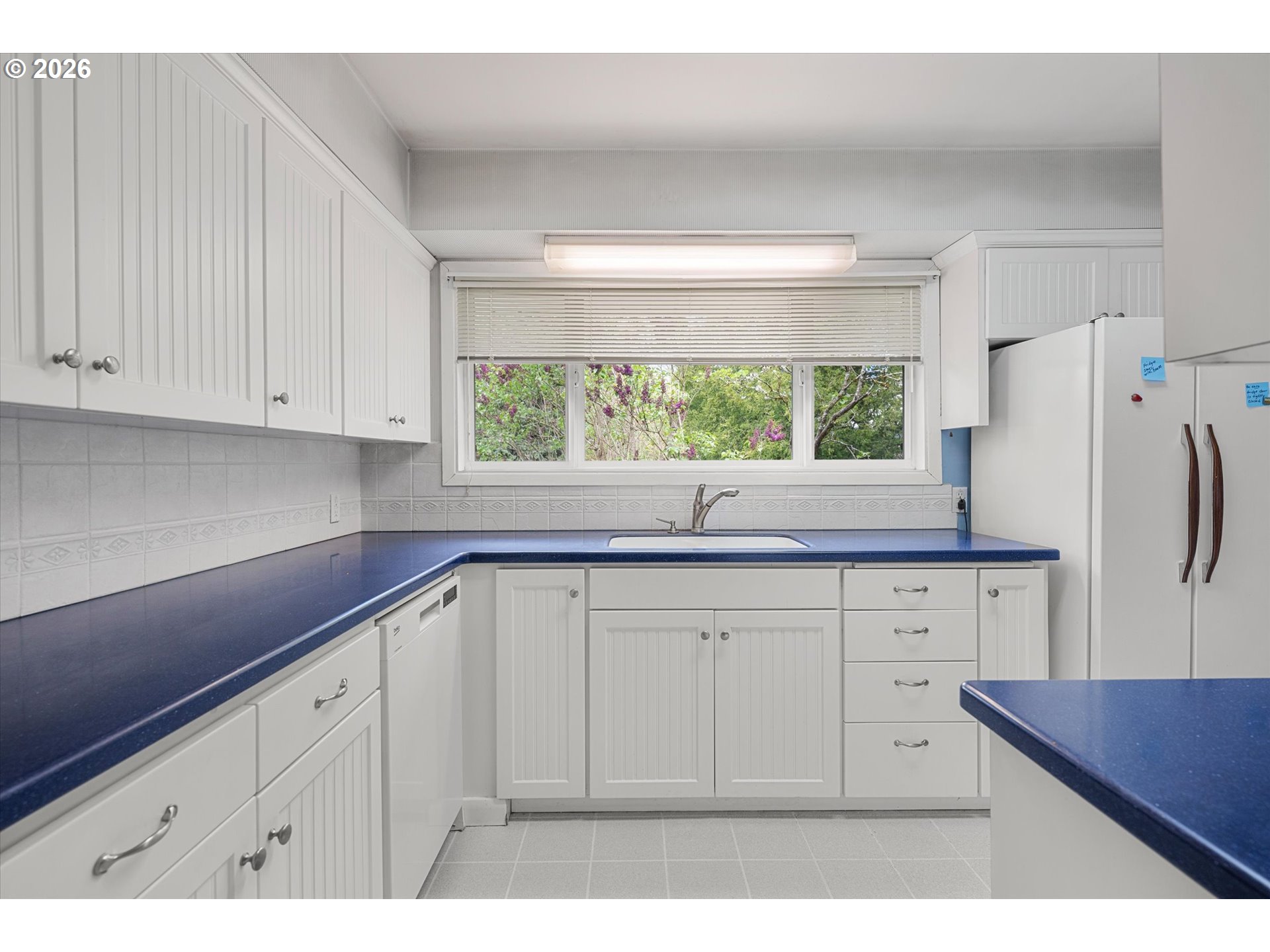 3235 Southeast Silver Springs Road Milwaukie, OR 97222 - Photo 9 of 32 a kitchen with granite countertop white cabinets white appliances and sink