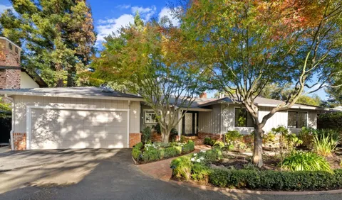 a front view of a house with garden