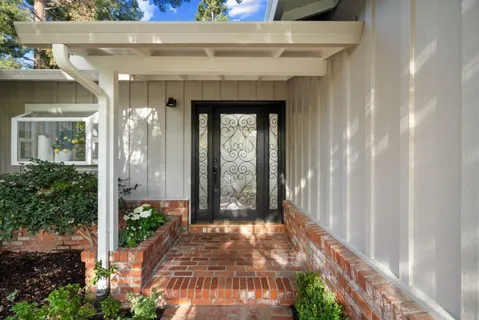 a living room with fireplace furniture and a large window